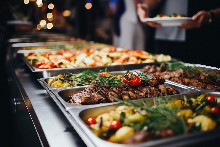 People gathering for food prepared by caterer.