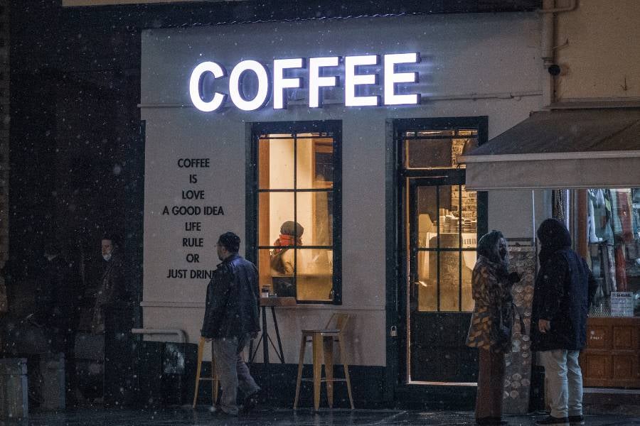 Coffeeshop with neon "COFFEE" sign.