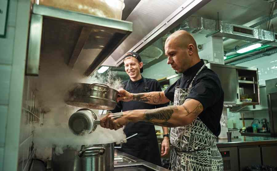 Two cooks are busy in the kitchen.