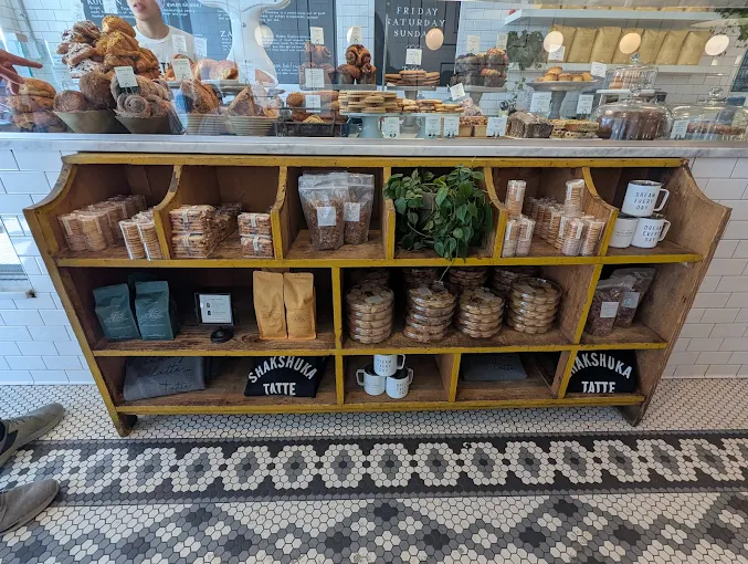 Tatte Bakery keeping coffee and market-style items under the display counter.