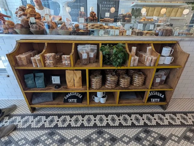Tatte Bakery keeping coffee and market-style items under the display counter.