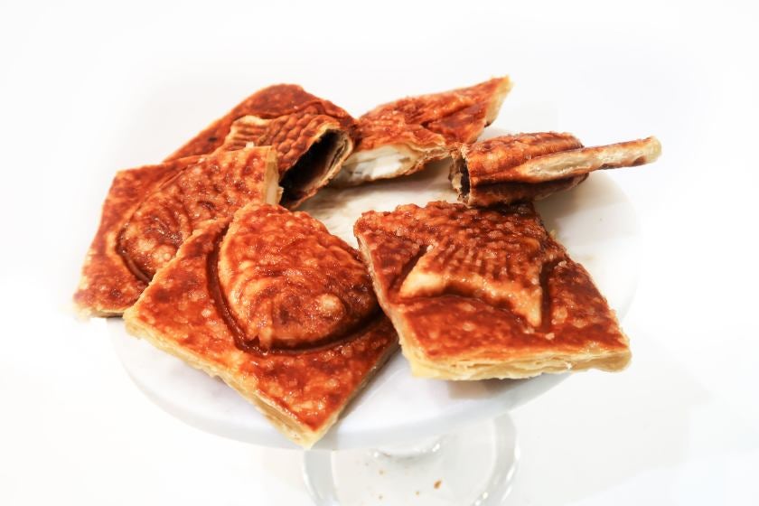 Fish-shaped korean bread cut on a platter.