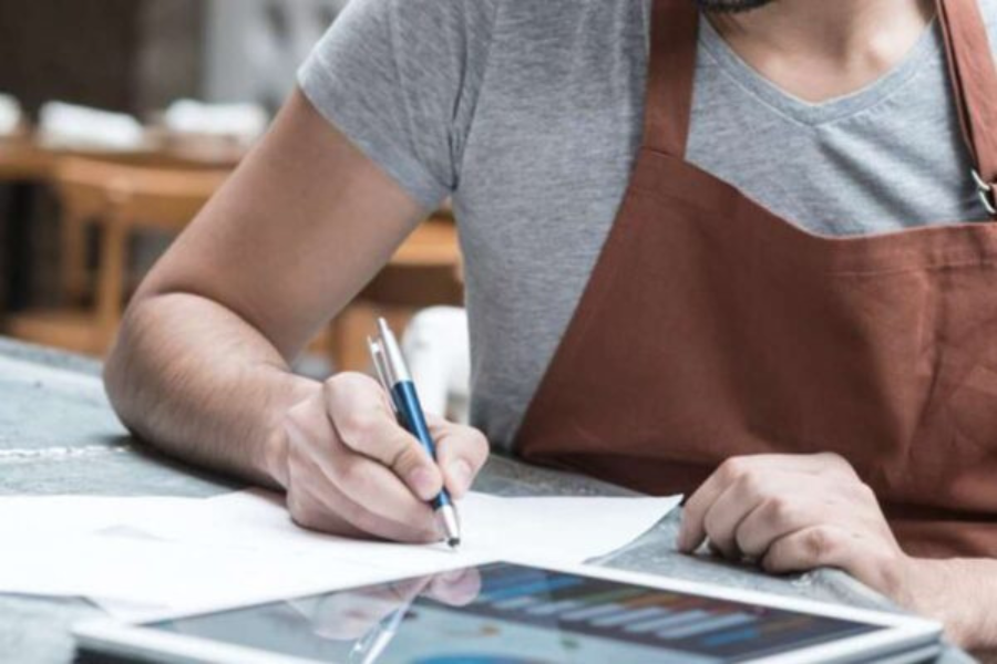 Woman writing on a paper.