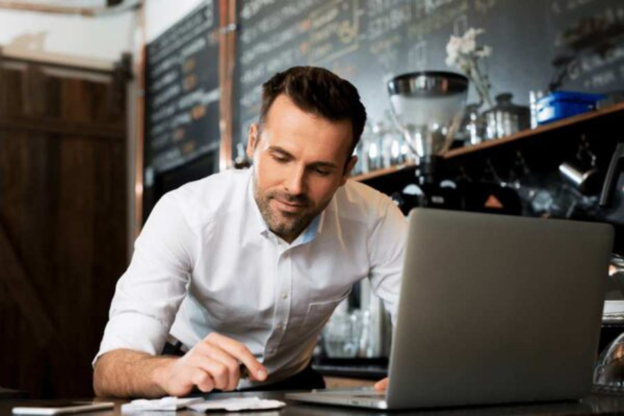 restaurant owner working on laptop
