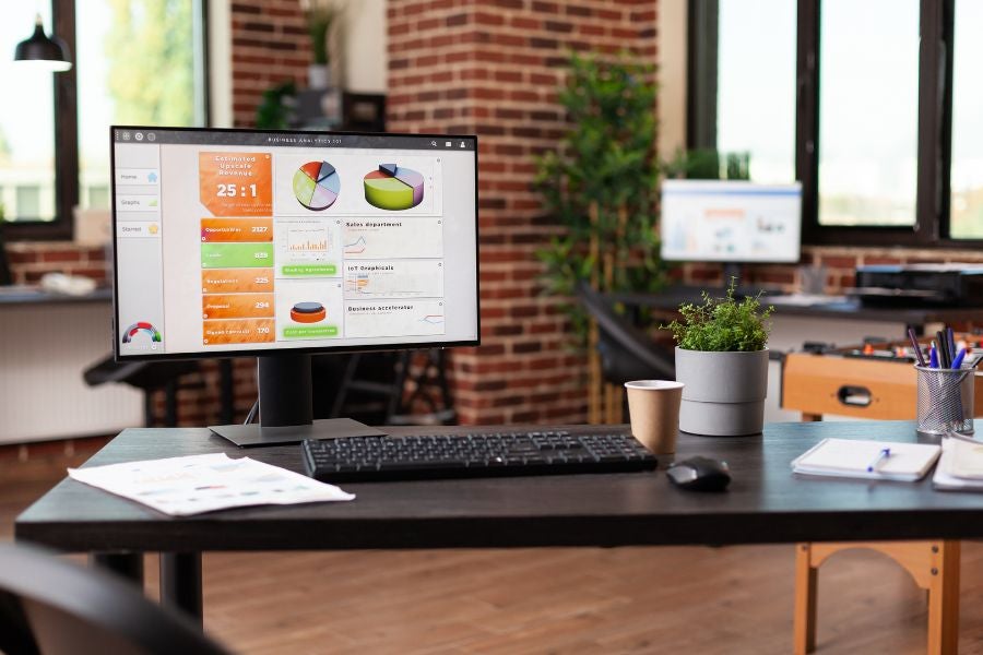 Empty business office with computer and instruments on desk.